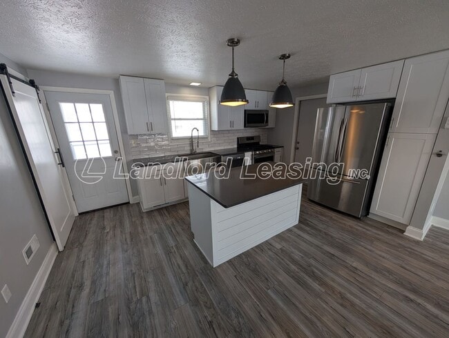 Building Photo - Updated 3-Bedroom Split-Level with Open Kitchen & Finished Lower Level