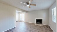 Located at 1359 Yorkland Rd. in Columbus, Ohio, this two-story home offers a well-organized layout spread across two floors. The main level features a welcoming living room with hardwood-style flooring, a ceiling fan, a wood-burning fireplace, and French doors that invite natural light and provide access to the outdoors. The kitchen is equipped with white shaker-style cabinetry, granite-look countertops, a stainless steel sink, and black appliances including a gas range, over-the-range microwave, and dishwasher — all set atop durable wood-style flooring. A half bathroom on the main level features a white vanity with a mirror and wood-style flooring beneath a vaulted ceiling. The staircase connects the main floor to the upper level, where two carpeted bedrooms await. Each bedroom is fitted with a ceiling fan and window for natural light. The spacious primary bedroom offers generous room to accommodate a full suite of furnishings. The second bedroom includes a closet and direct access to the hallway. A full bathroom on the upper level provides a white vanity, mirrored medicine cabinet, and a tub-shower combination. Throughout the home, neutral tones and textured ceilings create a clean, cohesive aesthetic.