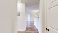 Located on Summerhill Club Lane in Titusville, Florida, this well-appointed 2-bedroom, 3-bathroom single-floor residence offers a thoughtfully designed layout with a clean, bright aesthetic throughout. Wood-look flooring flows consistently across the living areas and bedrooms, complementing the crisp white walls and creating a cohesive, modern feel.

The entrance opens into a wide hallway that connects the main living areas. The open-plan dining and living room is bathed in natural light and features a decorative pendant light fixture that anchors the dining area. The kitchen is efficiently laid out in a galley style, equipped with stainless steel appliances including a refrigerator, range, microwave, and dishwasher, alongside warm-toned wood cabinetry and white countertops.

Both bedrooms are comfortably sized, with the primary bedroom offering a ceiling fan, a large window with outdoor views, and access to ample closet space, including a walk-in closet with wire shelving. Three full bathrooms include tub-shower combinations with white tile surrounds, wood-toned vanities, and tile flooring.

Additional highlights include a dedicated laundry area, multiple closets for generous storage, and a private balcony. The overall ambiance is light, clean, and functional, making this residence an practical and comfortable home.