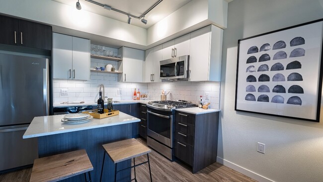 Beautiful finishes include subway tile backsplash - Modera South Lake Union