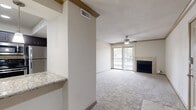 Located in Seabrook, TX, this 2-bedroom, 1-bathroom single-story home offers a well-organized layout that makes efficient use of its floor area. The living room serves as the heart of the home, featuring plush carpeting, a ceiling fan, crown molding, and a tile-surround fireplace. A sliding glass door opens to a private balcony, filling the room with natural light and providing outdoor views. Adjacent to the living area, the kitchen is well-appointed with rich dark cabinetry, granite countertops, a tile backsplash, and a full suite of stainless steel appliances including a range, dishwasher, and refrigerator. Light tile flooring completes the kitchen space. A hallway connects the living areas to the bedrooms, both of which are carpeted and equipped with ceiling fans. The primary bedroom is generously sized and includes two closets and direct access to the shared bathroom. The bathroom features tile flooring, a vanity with granite countertops, dark cabinetry, and a tiled tub-shower combination. Two closets provide practical storage throughout the home. Textured ceilings and neutral tones create a consistent, clean aesthetic throughout the entire space.