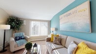 Located at 8 Michael Rd in New London, Connecticut, this single-floor residence offers a well-designed layout with a cohesive coastal aesthetic throughout. The living area is bright and welcoming, featuring a large window with vertical blinds that allows generous natural light to fill the carpeted space. A signature teal accent wall adds a bold pop of color, complementing the neutral tones that run throughout the home.

The kitchen is thoughtfully appointed with warm oak cabinetry, dark countertops, and light hardwood-style flooring. White appliances, including a range, dishwasher, and ample upper and lower cabinet storage, make this a fully functional cooking space.

The bedrooms are generously proportioned, each featuring plush carpeting, large windows, and ample closet space with built-in shelving. The rooms carry a calming, neutral palette accented by coastal-themed artwork, creating a serene retreat atmosphere.

The full bathroom is clean and well-organized, featuring a tub-shower combination, a wood-toned vanity with under-sink storage, a mirrored medicine cabinet with overhead lighting, and hardwood-style flooring. Nautical accents reinforce the home's consistent coastal theme.

Overall, this residence presents a bright, comfortable, and cohesive living environment with thoughtful design details throughout.