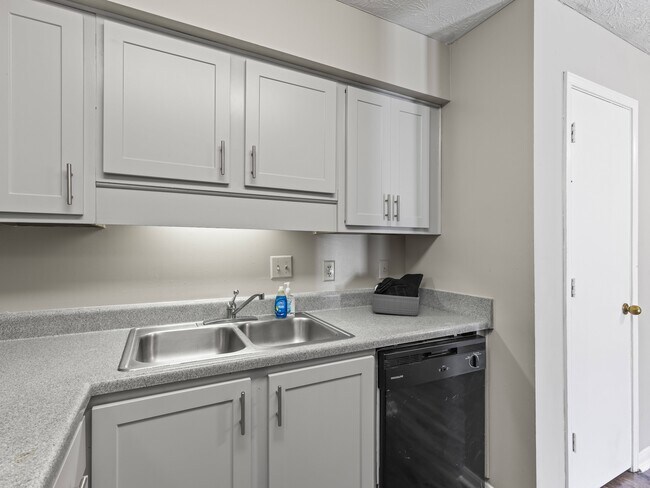 Our Montgomery apartments at Stratford Village offer convenient kitchens with dishwasher, sink, and ample cabinet storage, professionally operated by Highlands Vista Group. - Stratford Village