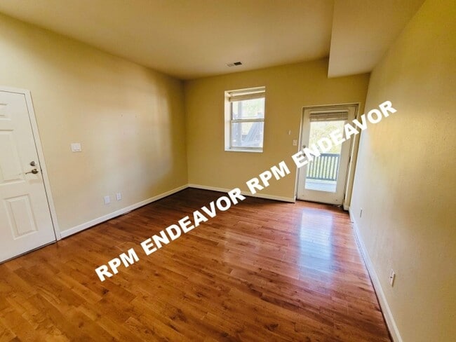 Building Photo - "Charming 2-Bed Condo with Bay Window & Ga...