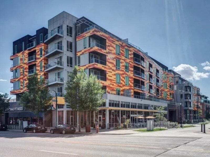 Exterior view of a modern apartment building with colorful facade and balconies.