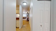 This single-floor residence offers a thoughtfully designed layout that connects its key living spaces through a tiled entry hallway. Upon entry, tile flooring guides residents past the kitchen and toward the main living areas, transitioning to plush carpeting throughout the rest of the home.

The kitchen is well-equipped with stainless steel appliances, including an electric range and over-the-range microwave, complemented by rich granite countertops and white cabinetry that provides ample storage. The living room is bright and inviting, featuring large sliding glass doors and additional windows that frame views of the surrounding greenery, filling the space with natural light.

The bedrooms are carpeted and comfortably proportioned, each offering closet space and windows with natural light. One bedroom includes a walk-in closet accessible through a dedicated door.

The residence includes two bathrooms. The primary bathroom features a glass-enclosed shower stall and granite vanity countertop with white cabinetry. The secondary bathroom offers a full tub-shower combination with a handheld showerhead, also finished with matching granite countertops and tile flooring throughout.