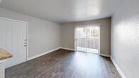 Located at 7879 Riverfall Dr in Dallas, TX, this single-story, 1-bedroom, 2-bathroom home offers a practical and well-organized layout. Wood-look flooring runs throughout the space, complemented by neutral gray walls and clean white baseboards that create a bright, cohesive aesthetic.

The open-concept living, dining, and kitchen area forms the heart of the home. The living room features a textured ceiling, a sliding glass door fitted with vertical blinds, and direct access to a private patio, allowing natural light to fill the space. The kitchen is efficiently designed with granite countertops, a tile backsplash, and stainless steel appliances, with a pass-through counter that connects it to the living and dining area. A dedicated pantry provides additional storage.

The bedroom is comfortably sized, featuring a window with natural light, a closet, and the same consistent wood-look flooring. A hallway connects the bedroom to the two bathrooms, one of which includes a full tub-shower combination with white tile surround. Two closets throughout the home offer practical storage solutions.

The textured ceilings, neutral color palette, and consistent finishes throughout lend the space a clean, move-in-ready feel suited for comfortable everyday living.