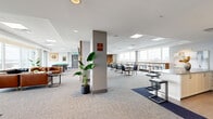 Located at 833 Richmond Road in Ottawa, this generously sized amenity lounge spans a single floor and offers a thoughtfully designed multi-functional space. Floor-to-ceiling windows line the perimeter, flooding the interior with natural light and framing sweeping views of the Ottawa River and the surrounding cityscape. The open-concept layout is organized into several distinct zones that flow seamlessly into one another. A comfortable lounge area features tufted leather seating arranged around low coffee tables, ideal for relaxed gatherings. Adjacent to this, a window-side bar counter with sleek stools provides an elevated vantage point for taking in the panoramic views. A dedicated games area includes a pool table and dartboard for recreational use. The space also incorporates a dining and café-style seating section with modern chairs and tables. A full kitchen fitted with white cabinetry, stainless steel appliances, and an island with bar seating serves as a functional hub for entertaining. Soft carpet flooring in neutral tones, recessed and panel lighting, and potted greenery contribute to a welcoming, contemporary ambiance. An entry foyer with elevator access connects the space conveniently, while glass doors lead to an outdoor terrace area.