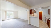 Located at 36780 Harper Ave in Clinton Township, MI, this 2-bedroom, 1-bathroom unit offers a practical and well-organized single-floor layout. The entrance opens into a carpeted living room that benefits from natural light through a large window, with vaulted ceilings adding a sense of spaciousness beyond the unit's footprint. The living area flows seamlessly into a dedicated dining space, both finished with neutral-toned carpet throughout.

The kitchen features rich, dark cherry wood cabinetry, white appliances including a refrigerator and dishwasher, light-tiled flooring, and a pass-through counter that connects to the main living area. A hallway with a closet leads to the two bedrooms. The primary bedroom is generously sized and includes a large bi-fold closet with warm wood-toned doors, along with an additional closet for extra storage. The second bedroom is bright and carpeted, with a large window fitted with vertical blinds that fill the room with natural light.

The bathroom is clean and functional, featuring a full tub-shower combination surrounded by classic white square tile and chrome fixtures. With four closets total distributed throughout the unit, storage is a notable strength of this space. The neutral color palette and consistent carpeting create a cohesive, move-in-ready interior.