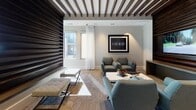 This single-floor space is thoughtfully designed to balance functional meeting areas with comfortable lounge settings. A striking dark wood slatted accent wall serves as the centerpiece of the lounge area, extending from floor to ceiling and creating a bold visual contrast against the neutral gray walls. Matching dark wood beams run across the ceiling above, adding depth and a cohesive design language throughout the space. Carpeted flooring in a warm, textured pattern grounds the room and complements the contemporary furnishings, which include teal upholstered chairs, a sleek white coffee table, and tufted bench ottomans.

Natural light streams generously through multiple large windows dressed with sheer white curtains, creating an airy, welcoming ambiance. A wall-mounted flat-screen television is integrated into the slatted accent wall, enhancing the lounge's functionality.

The conference area features a long granite-topped table surrounded by dark leather chairs, bathed in sunlight from oversized windows with views of the surrounding exterior. A glass-paneled interior door connects the lounge to an adjacent corridor, maintaining visual openness while defining distinct zones. Overall, the space conveys a professional yet inviting atmosphere suited for both collaboration and relaxation.