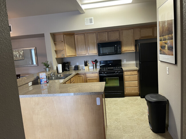 View of the kitchen from the hallway - Rabbitbrush Run Apartments