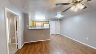 Located at 1088 Park Plaza in Austin, TX, this one-bedroom, one-bathroom unit offers a well-organized, single-floor layout designed for efficient everyday living. The open living area features warm wood-look flooring, neutral gray walls, and a ceiling fan with light fixture, creating a bright and inviting atmosphere. A window with blinds allows natural light to flow in, while a front entry door with glass panels adds a welcoming touch. A dedicated closet provides convenient in-unit storage.

The kitchen is designed around a peninsula counter with a speckled laminate surface that opens to the living area, making the space feel connected and functional. Warm-toned wood cabinetry lines the walls, offering ample storage, while white appliances — including a refrigerator, electric range, and over-the-range microwave — provide full cooking capability. Wood-look flooring continues throughout the kitchen.

The bedroom is a comfortable, well-proportioned room featuring plush carpet, a ceiling fan, a window for natural light, and an open closet with hanging rod. The full bathroom includes a tiled shower-tub combo, wood-look flooring, a wall mirror, and a vanity, rounding out this practical and livable Austin residence.
