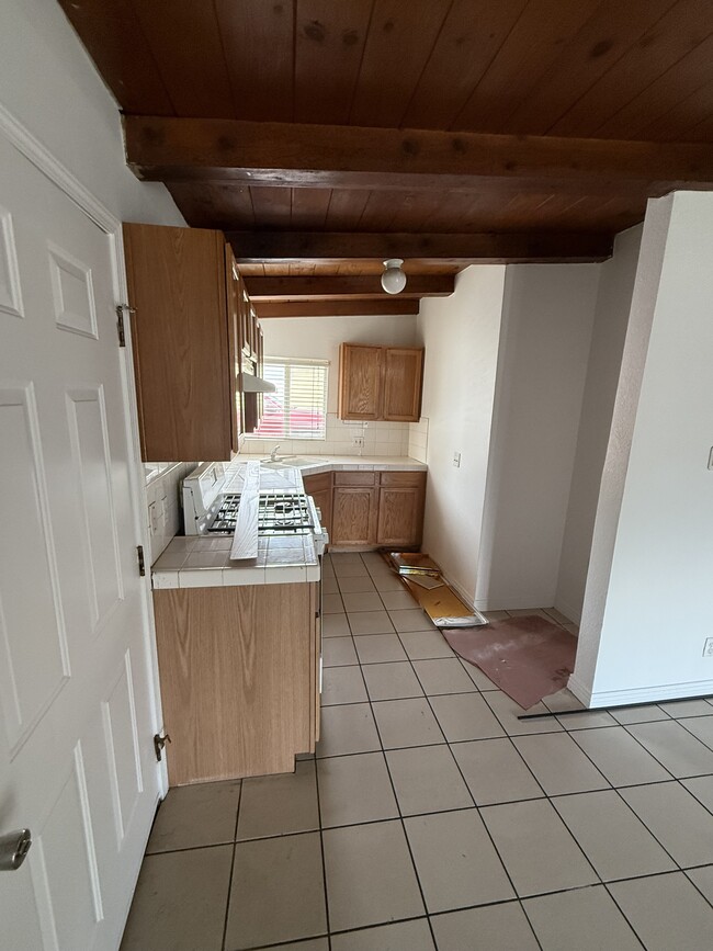 Kitchen, front door at left - 4950 Howard St