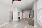 Located at 1717 Religious St in New Orleans, Louisiana, this two-bedroom, one-bathroom unit offers a thoughtfully designed single-floor layout with a clean, modern aesthetic. Polished concrete floors flow throughout the entire space, lending a contemporary industrial feel that ties each room together cohesively.

The kitchen is a standout feature, outfitted with grey shaker-style cabinetry extending to the ceiling for generous storage, granite-look countertops, and a full suite of stainless steel appliances including a gas range, refrigerator, and dishwasher. The open layout adjacent to the kitchen provides a bright, airy living area enhanced by natural light from large windows with blinds.

The primary bedroom is a comfortable, well-proportioned room with dual windows that invite natural light. The second bedroom is similarly neutral and versatile, featuring an accessible electrical panel built into the wall.

The bathroom is designed with accessibility in mind, equipped with grab bars, a spacious roll-in shower, and a granite-topped vanity with an open under-sink space. A dedicated in-unit laundry area with a side-by-side washer and dryer adds everyday convenience. Recessed lighting and a ceiling fan complete the practical and modern character of this well-appointed New Orleans residence.