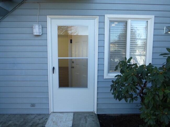 Front door and cheery kitchen window. - 215 8th St SE