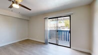 Located at 4707 E McDowell Rd in Phoenix, AZ, this single-floor unit offers four bedrooms and two full bathrooms within a compact, efficiently designed layout. Light wood-style flooring runs throughout, creating a cohesive and clean aesthetic across all rooms.

The living room is bright and open, featuring a ceiling fan and sliding glass doors that lead to a private balcony, allowing natural light to flow in and providing outdoor views of the surrounding community. The galley-style kitchen is well-appointed with white shaker cabinetry, subway tile backsplash, stone countertops, stainless steel appliances including a range, dishwasher, refrigerator, and built-in microwave, plus a dedicated pantry for additional storage.

Each bedroom is finished with the same light flooring and ceiling fans, maintaining a consistent, comfortable feel. The primary bedroom includes a sliding glass door to the balcony, while additional bedrooms feature windows with blinds and generous closet space with sliding doors. Both bathrooms are clean and functional, each equipped with a shower-tub combination and vanity with storage. The overall design is neutral and move-in ready, offering a practical living space suited for Phoenix's warm climate.