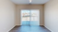 This well-designed apartment in Cedar Rapids, Iowa, maximizes its 640 square feet of living space. The single-floor layout includes a spacious 130 square foot bedroom, a full bathroom, and an open-concept kitchen and living area. The interior boasts modern finishes throughout, with neutral-toned walls and contemporary fixtures.

The bedroom features plush carpeting, a ceiling fan, and a large window offering city views. The bathroom is equipped with a vanity, toilet, and tub/shower combination, finished with wood-look flooring for a warm touch. The kitchen impresses with its taupe cabinetry, stainless steel appliances, and a convenient island that doubles as a breakfast bar.

The living area seamlessly connects to the kitchen, creating an open and airy feel. Large windows flood the space with natural light and provide scenic urban vistas. Durable laminate flooring unifies the common areas, enhancing the apartment's modern aesthetic.

A dedicated laundry room with full-sized washer and dryer adds convenience to this compact living space. The hallway provides access to all rooms, ensuring an efficient flow throughout the apartment. Despite its modest size, this well-appointed urban dwelling offers comfortable living in the heart of Cedar Rapids.