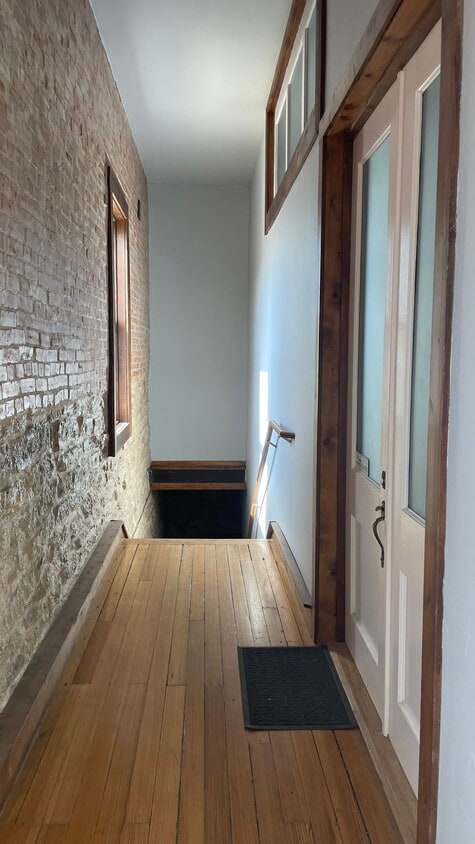 Access the stairs through a door located in Art Alley. - 121 Clifton Art Aly