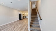 Located at 2500 Tiny Town Rd in Clarksville, TN, this two-story home offers 3 bedrooms and 2 bathrooms across a thoughtfully designed layout. The main floor hosts a combined kitchen and living area, where light wood-style luxury vinyl flooring flows throughout. The kitchen is equipped with stainless steel appliances—including a refrigerator with ice maker, electric range, built-in microwave, and dishwasher—complemented by white shaker cabinetry, granite countertops, and stylish pendant lighting. The open living area features recessed lighting and a front-facing window that invites natural light. The upper floor contains all three bedrooms, connected by a central hallway with clean panel-style doors. The primary bedroom offers ample space with a ceiling fan and natural light. Additional bedrooms feature plush carpeting and generous closet space. Both bathrooms are finished in a clean, contemporary style with white surrounds, soaking tub/shower combinations, white vanity cabinetry with matte black hardware, and wood-style flooring. Neutral tones and consistent finishes throughout create a cohesive, move-in-ready aesthetic ideal for comfortable everyday living.