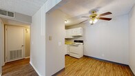 Located at 111 Whitsett Rd in Nashville, TN, this one-bedroom, one-bathroom unit offers a thoughtfully arranged single-floor layout that maximizes its compact footprint. The living room is bright and open, featuring wood-style plank flooring, neutral warm-toned walls, and a textured ceiling. A sliding glass door leads to a private balcony, filling the space with natural light and providing views of the surrounding outdoor area. A ceiling fan with a brass light fixture anchors the living area, adding both function and character.

The kitchen is efficiently designed in an L-shaped configuration, equipped with white cabinetry, yellow laminate countertops, a white electric range, a dishwasher, and an under-cabinet range hood. Wood-style flooring continues through this space, maintaining visual continuity with the living area.

The bedroom offers a comfortable, carpeted retreat with a dedicated closet and an additional closet nearby for ample storage. A window allows natural light to brighten the room. A connecting hallway links the bedroom to the rest of the unit and provides access to two closets in total.

The bathroom is clean and straightforward, featuring a white vanity with under-sink storage, a well-lit mirror, and hardwood-style flooring. The textured ceiling is consistent throughout the unit, giving the home a cohesive, unified aesthetic.