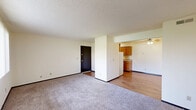 Located at 3403 Jersey Ridge Rd in Davenport, Iowa, this two-bedroom, one-bathroom residence offers a practical and comfortable single-floor layout. The open living area greets you at the entrance, featuring neutral-toned carpet, a textured ceiling, and a view into the kitchen, creating a cohesive and functional flow throughout the space.

The galley-style kitchen is well-appointed with warm honey-toned wood cabinetry lining both walls, ample upper and lower storage, a tile backsplash, a double sink, and hardwood-style flooring. White appliances, including a refrigerator and electric range, are included.

Both bedrooms are carpeted and feature neutral walls, textured ceilings, and large windows with vertical blinds that allow for generous natural light. The spacious primary bedroom provides ample room for furnishings, while the second bedroom offers versatility as a guest room or home office. A dedicated closet adds practical storage to the unit.

The bathroom includes a wide vanity with an integrated sink, wood cabinetry below, and a well-lit mirror backed by a multi-bulb light fixture. Overall, the residence presents a clean, functional design with consistent finishes throughout, making it a straightforward and livable space in a convenient Davenport location.