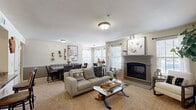 Located at 2737 NW 140th St in Oklahoma City, OK, this thoughtfully designed one-bedroom, two-bathroom residence offers a comfortable and functional single-floor layout. The open-concept living and dining area serves as the heart of the home, featuring a carpet-floored living room with a classic fireplace framed by a grey mantel, multiple windows with blinds that invite abundant natural light, and seamless flow into the dining space. The kitchen is well-appointed with rich dark wood cabinetry, granite-style countertops, stainless steel appliances including a range, microwave, and dishwasher, and tile flooring — all complemented by a convenient pantry for additional storage. The generously sized primary bedroom offers a ceiling fan, plush carpeting, a bay window, and direct access to one of the two bathrooms. The adjacent bathroom features dark wood vanity cabinetry with stone-look countertops, a tub-shower combination with tile surround, and tile flooring. A dedicated closet and hallway complete the layout, adding to the practicality of the space. Overall, the residence presents a warm, neutral palette with cohesive finishes throughout.
