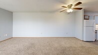 Located at 3420 Mason Rd in Burlington, Iowa, this 2-bedroom, 1-bathroom unit offers a practical and comfortable single-floor layout. The kitchen is well-equipped with ample cabinetry featuring wood-trimmed light blue cabinet doors, laminate countertops, a double sink, and white appliances including a refrigerator, dishwasher, and electric range. Light wood-style vinyl flooring runs throughout the kitchen, giving it a clean, bright appearance. The spacious living area is carpeted and features a ceiling fan with a light fixture, providing a comfortable and airy atmosphere. Both bedrooms are carpeted and finished with warm wood-trimmed doors and baseboards. The primary bedroom offers generous space along with a double-door closet, while the second bedroom benefits from a large window that invites natural light and outdoor views. The bathroom is designed with accessibility in mind, featuring grab bars near the toilet and bathtub, a full tub/shower combination, and durable wood-style vinyl flooring. Throughout the unit, neutral wall tones and consistent wood-trimmed finishes create a cohesive and understated aesthetic. This unit is a practical choice for those seeking a straightforward, move-in-ready home in Burlington, IA.
