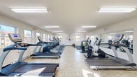 Located at 2828 Egypt Rd in Norristown, PA, this fitness center offers a dedicated, single-floor exercise room designed to support a well-rounded cardio workout routine. The space is bright and welcoming, with white walls, light-toned tile flooring, and multiple windows along the perimeter that invite generous natural light and views of the surrounding outdoor scenery.

The exercise room is outfitted with a comprehensive lineup of TRUE-brand cardio equipment, including treadmills, elliptical machines, stair climbers, and stationary and recumbent bikes — providing a variety of options for users of different fitness levels. A large wall-mounted mirror along one side of the room enhances the sense of openness and allows users to monitor their form during workouts. Flush fluorescent ceiling fixtures provide consistent, even lighting throughout the space.

A dedicated stretching and floor exercise area features exercise mats and a stability ball, offering space for warm-ups, cool-downs, or low-impact workouts. The room also includes a wall clock, a first aid kit, and an AED unit, reflecting a commitment to user safety. A wall-mounted split air conditioning unit ensures comfortable temperatures year-round. The space is accessed through a clearly marked exit door, contributing to an organized and functional layout overall.