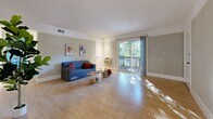 Located at 200 Coggins Dr in Pleasant Hill, CA, this 2-bedroom, 1-bathroom home offers a thoughtfully organized single-floor layout. The living room is bright and welcoming, featuring light hardwood flooring, soft sage-green walls, and a sliding glass door that invites abundant natural light and outdoor views of surrounding greenery. A chandelier-lit hallway connects the living area to the rest of the home, reinforcing a clean, cohesive aesthetic throughout.

The combined dining room and kitchen features a galley-style design with white cabinetry, granite-style countertops, stainless steel appliances, and hardwood flooring — offering an efficient and well-equipped cooking space.

Both bedrooms are carpeted and dressed in the same muted green palette. The primary bedroom is a comfortable size and includes sliding closet doors, providing practical storage. The second bedroom features a wide window framing views of mature trees outside, filling the room with natural light.

The bathroom is neatly finished with a white vanity, granite countertop, wood-look flooring, and a tiled shower-tub combination with glass sliding doors. Additional spaces include a laundry area, a utility room, and two closets, rounding out the home's practical offerings.