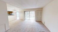 This 780 square foot apartment, located at 1015 Cloister Road Apt. A in Wilmington, Delaware, offers a well-designed single-floor living space. The layout comprises a combined dining room, kitchen, and living room area, one bedroom, a closet, and a hallway. The primary bedroom is generously sized at 190 square feet, providing ample space for rest and relaxation.

The apartment features neutral-toned walls and carpeted floors throughout, creating a cohesive and adaptable living environment. Large windows in various rooms allow for abundant natural light, brightening the space and offering views of the surrounding area. The kitchen is equipped with light wood cabinetry, granite countertops, and white appliances, including a refrigerator.

The living and dining areas are open-plan, with a charming chandelier-style light fixture adding a touch of elegance to the dining space. A pass-through window from the kitchen to the dining area enhances the flow between these spaces. The bedroom includes a built-in closet with louvered doors, maximizing storage efficiency.

Overall, this apartment presents a comfortable and functional living space with a neutral palette, allowing for easy personalization to suit individual tastes and needs.