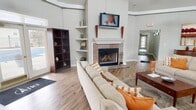This 1700 square foot single-floor residential complex in Speedway, IN, boasts an array of thoughtfully designed communal spaces. The fitness center is a standout feature, equipped with state-of-the-art cardio and strength training equipment. Its light blue walls, mirrored sections, and ample natural light create an invigorating atmosphere for workouts.

The lounge area serves as the heart of the complex, featuring a cozy fireplace flanked by built-in shelving. The space is adorned with comfortable seating, warm wood flooring, and stylish decor, promoting a welcoming environment for relaxation and socialization.

A communal kitchen area, complete with modern appliances and ample counter space, provides residents with a functional space for meal preparation and gatherings. The open layout seamlessly connects to other common areas, enhancing the overall flow of the space.

The complex also includes a reception area with high ceilings and large windows, flooding the space with natural light. Throughout, ceiling fans and recessed lighting fixtures contribute to the overall comfort and ambiance.

The cohesive design, featuring a neutral color palette and consistent flooring, ties all areas together, creating a harmonious living environment that caters to various resident needs and preferences.