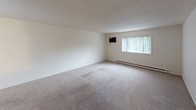 Located at 29 Boyer Dr in Battle Creek, Michigan, this single-floor unit offers a practical and well-organized layout. The expansive living area is finished with neutral wall-to-wall carpeting and features a ceiling fan, a wall-mounted air conditioning unit, and baseboard heating, ensuring year-round comfort. Large windows throughout invite natural light and offer views of the surrounding greenery. The open flow between the main living spaces makes the floor plan feel connected and versatile.

The galley-style kitchen is efficiently designed with white cabinetry lining both sides, dark granite-style countertops, a decorative tile backsplash, a stainless steel sink, and white appliances including a refrigerator, electric range, and over-the-range microwave. Tile flooring completes the kitchen's clean and functional aesthetic.

The bedrooms are carpeted and well-proportioned, each benefiting from natural light. A standout feature is the spacious reach-in closet fitted with louvered bifold doors and a built-in shelving unit, providing excellent storage organization.

The bathroom is appointed with a double-sink vanity topped with a marble-style countertop, white cabinetry, a lighted medicine cabinet, and a full tub-shower combination, all set on tile flooring for easy maintenance.