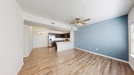 Located at 2717 NW 178th St in Oklahoma City, Oklahoma, this 2-bedroom, 1-bathroom single-floor home offers a practical and well-appointed layout. The open-concept living and kitchen area forms the heart of the home, where wood-look flooring, a ceiling fan with light fixture, and a decorative chandelier create a welcoming atmosphere. A blue accent wall adds a touch of color to the living space, which receives natural light through a large window.

The kitchen is outfitted with rich, dark wood cabinetry extending to the ceiling for ample storage, granite-look countertops, a stainless steel refrigerator with ice and water dispenser, an electric range, and a built-in microwave. A peninsula provides additional counter space and separates the kitchen from the living area.

The primary bedroom offers a generous footprint with carpet flooring, a double door closet, and a window for natural light. The second bedroom features soft blue-gray walls, wood-look flooring, and a bright window. The bathroom includes dark wood cabinetry, granite-look countertops, and a full tub-shower combination. A dedicated laundry room with side-by-side washer and dryer hookups completes this efficiently designed home.