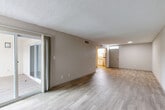 Located at 4581 South Kirkman Road in Orlando, Florida, this single-floor, 3-bedroom, 2-bathroom residence offers a well-organized layout designed for comfortable everyday living. Throughout the home, light-toned wood-look flooring creates a cohesive and clean aesthetic, complemented by neutral wall tones and textured ceilings.

The open combined living and dining area is generously proportioned, filled with natural light from large windows and a sliding glass door that leads to a private balcony. The kitchen is a standout feature, outfitted with crisp white shaker cabinetry, granite countertops, and stainless steel appliances, including an electric range and built-in microwave.

The spacious primary bedroom offers ample room for furnishings, while each of the three bedrooms includes closet storage — with seven closets spread throughout the home providing excellent organizational capacity. The two bathrooms are finished with granite-topped vanities and full shower-tub combinations with updated fixtures.

Additional spaces include a dedicated laundry area, a utility room, and a hallway connecting the private quarters. The home's practical layout, abundant storage, and modern finishes make it a functional and inviting residence in the heart of Orlando.