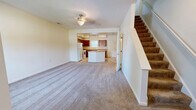 Located at 1301 Meadow Brook Ln in Northvue, PA, this two-story, 2-bedroom, 3-bathroom home offers a practical and well-organized layout across two floors. The main level welcomes you through a dedicated entrance and opens into a spacious combined kitchen and living area. The kitchen is outfitted with rich cherry wood cabinetry, ample counter space, a peninsula island, and white appliances including a refrigerator, range, and dishwasher. Stone-tile flooring runs throughout the kitchen and bathrooms, lending a clean, durable aesthetic. The open living room, complete with a ceiling fan, flows naturally from the kitchen and connects to the carpeted staircase leading to the upper level. The second floor houses both bedrooms, each carpeted and featuring ceiling fans and windows that bring in natural light. The generously sized primary bedroom includes a closet and direct access to the hallway. Three bathrooms—including one with a full tub/shower combination, warm-toned tile flooring, and cherry wood vanity—serve the home. A dedicated laundry room and additional closet storage add functional convenience. The home's neutral color palette and clean finishes create a bright, move-in-ready atmosphere throughout.