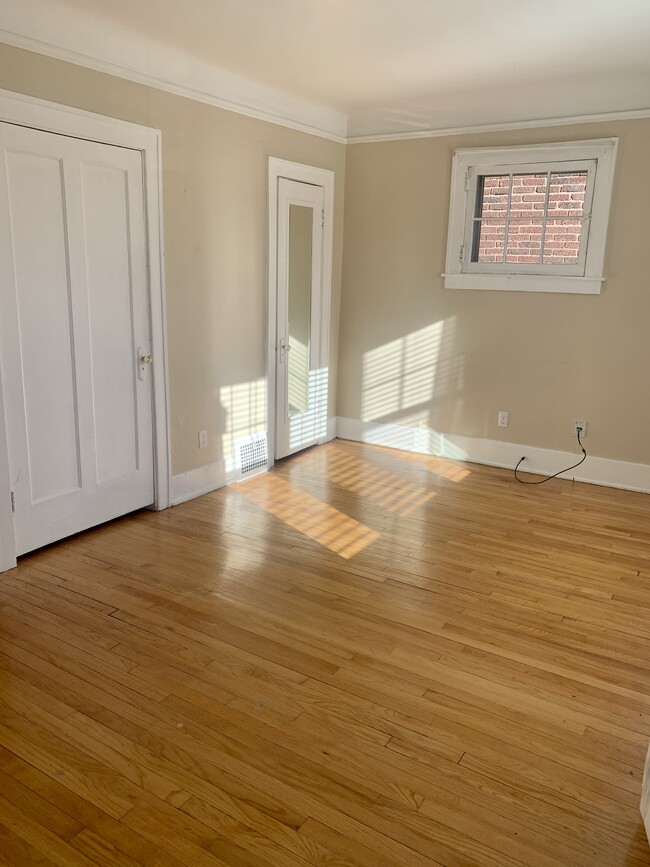Living room with large closets and hardwood flooring - 602 W 3rd St