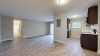 Located at 6418 Stumph Rd in Parma Heights, Ohio, this single-floor unit has been thoughtfully updated with a clean, contemporary aesthetic throughout. Light-toned vinyl plank flooring runs consistently across the living areas, bedrooms, and kitchen, creating a cohesive and easy-to-maintain interior.

The spacious living room is a standout feature, offering an open and airy feel with neutral gray walls, crisp white baseboards, and a sliding glass door that leads to an outdoor balcony, flooding the space with natural light and providing views of the surrounding greenery.

The kitchen is well-appointed with dark espresso cabinetry, light countertops, and a full suite of stainless steel appliances including a refrigerator, range, microwave, and dishwasher. A window above the sink brings in additional natural light. The kitchen connects seamlessly to the living area through a half-wall pass-through, enhancing the open-concept flow.

The bedrooms are generously sized, each featuring neutral tones and windows that frame natural outdoor views. The bathroom is clean and modern, with a dark vanity, white countertop, tub-shower combination, and wood-look flooring that ties in with the rest of the unit.

Overall, this space presents a fresh, move-in-ready environment with updated finishes throughout.