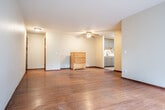 Located at 1018 Mayfair Ave in Madison, Wisconsin, this single-floor, three-bedroom, one-bathroom residence offers a practical and comfortable layout. Rich hardwood flooring extends throughout the main living areas and bedrooms, lending warmth and continuity to the space.

The open living and dining area is generously proportioned, featuring a large picture window dressed with vertical blinds that fills the room with natural light and offers views of surrounding greenery. A ceiling fan adds comfort, while baseboard heating ensures year-round warmth.

The updated kitchen is a standout feature, equipped with modern gray shaker-style cabinetry, a white subway tile backsplash, light vinyl plank flooring, and a full suite of stainless steel appliances including a gas range, over-the-range microwave, and refrigerator. A double-basin sink with a contemporary faucet completes the space.

The three bedrooms each feature hardwood floors, ceiling fans, and closet storage, with several rooms offering natural light through windows with outdoor views. The primary bedroom provides a comfortable and well-sized retreat.

The bathroom is cleanly appointed with gray cabinetry, a white countertop vanity, a tiled shower-tub combination, and a window for natural ventilation. With five closets distributed throughout, storage is ample across this well-organized home.