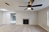 Located at 101 S Twin Creek Dr in Killeen, TX, this two-bedroom, two-bathroom residence offers a comfortable and functional single-floor layout. The open living room serves as the heart of the home, featuring light-toned luxury vinyl plank flooring, a ceiling fan with integrated lighting, a textured ceiling, and a classic wood-mantel fireplace as a central focal point. A large window allows natural light to fill the space, enhancing its warm, neutral color palette. A sliding barn-style door connects the living area to adjacent spaces, adding a practical design touch.

The galley-style kitchen is well-equipped with white cabinetry, subway tile backsplash, light-toned countertops, a double-basin sink, and black appliances including a range, microwave, and refrigerator. Light wood-look flooring carries through this space seamlessly.

Both bedrooms are carpeted and include ceiling fans, with the second bedroom offering dual closets for generous storage. The bathrooms feature tiled tub-shower combinations with clean, modern finishes. Additional conveniences include a dedicated laundry area, hallway, and a private balcony. The unit's neutral tones and consistent finishes throughout create a cohesive, move-in-ready living environment.