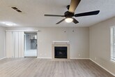 Located at 101 S Twin Creek Dr in Killeen, TX, this two-bedroom, two-bathroom residence offers a comfortable and functional single-floor layout. The open living room serves as the heart of the home, featuring light-toned luxury vinyl plank flooring, a ceiling fan with integrated lighting, a textured ceiling, and a classic wood-mantel fireplace as a central focal point. A large window allows natural light to fill the space, enhancing its warm, neutral color palette. A sliding barn-style door connects the living area to adjacent spaces, adding a practical design touch.

The galley-style kitchen is well-equipped with white cabinetry, subway tile backsplash, light-toned countertops, a double-basin sink, and black appliances including a range, microwave, and refrigerator. Light wood-look flooring carries through this space seamlessly.

Both bedrooms are carpeted and include ceiling fans, with the second bedroom offering dual closets for generous storage. The bathrooms feature tiled tub-shower combinations with clean, modern finishes. Additional conveniences include a dedicated laundry area, hallway, and a private balcony. The unit's neutral tones and consistent finishes throughout create a cohesive, move-in-ready living environment.