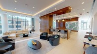 Located at 1326 S Michigan Ave in Chicago's South Loop, this elegantly designed amenity floor delivers a refined blend of comfort, functionality, and contemporary style. The main lounge area is anchored by rich warm wood wall paneling, coffered ceilings with subtle ambient lighting, and a curated mix of plush seating — including deep sectional sofas, curved accent chairs, and sleek black coffee tables. A bar-height counter with pendant lighting and high stools provides a versatile gathering space, complemented by a striking botanical artwork.

A dedicated game and social room features a billiard table beneath a dramatic constellation-style chandelier, alongside a large conference or game table for group activities. Floor-to-ceiling glazing throughout the space floods the interiors with natural light and frames expansive views of the Chicago skyline. A bright cafe-style lounge with tall marble bistro tables and bar stools sits directly against the curtain wall, offering an airy, sunlit retreat.

Additional spaces include a formal meeting room with a long wood table and sheer-draped windows, a clean white catering kitchen with marble countertops and a concrete-tile backsplash, a cozy nook with built-in shelving, and a welcoming entry with a coffee station. The overall aesthetic is modern and sophisticated throughout.