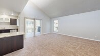 Located at 1801 E Girard Pl in Englewood, Colorado, this single-floor residence offers three bedrooms and two full bathrooms within a well-organized layout. The kitchen is a functional highlight of the home, featuring dark espresso cabinetry, granite countertops, a classic white subway tile backsplash, and a full suite of stainless steel appliances including a refrigerator, range, microwave, and dishwasher. Light tile flooring runs throughout the kitchen and living areas, lending a clean, cohesive look. The spacious primary bedroom stands out with vaulted ceilings that add a sense of openness, complemented by plush wall-to-wall carpeting found throughout all bedrooms. The two additional bedrooms are comfortable in size, each with neutral toned walls, carpet flooring, and natural light from windows. Both bathrooms are finished with warm beige tile surrounds in the tub/shower combinations, light wood-look tile flooring, dark vanity cabinetry, and granite countertops, creating a consistent and polished aesthetic. The overall design of the home reflects a modern yet approachable style, with neutral tones throughout that offer a versatile canvas for any décor preference.