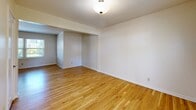 Located at 10381 SW Eastridge St in Portland, OR, this 2-bedroom, 1-bathroom home is spread across three floors, offering a well-organized and functional layout. Light hardwood flooring flows consistently throughout the living areas and bedrooms, lending warmth and cohesion to the interior.

The main living level features a spacious living room with clean white walls, hardwood floors, and a staircase with a classic black metal railing that connects the floors. The open flow between spaces gives the main level an airy, uncluttered feel.

The kitchen is equipped with stainless steel appliances, including a full-size refrigerator, dishwasher, and electric range. Warm wood cabinetry with tile countertops provides ample storage and workspace.

Both bedrooms continue the hardwood flooring theme and are finished with neutral tones. The primary bedroom is generously proportioned and includes multiple closets, offering notable storage capacity. The second bedroom benefits from a window with outdoor views, filling the room with natural light.

The bathroom features full white tile surround in the tub/shower area, tile flooring, and a window that provides natural ventilation and light. The home also includes three closets, a utility room, and a hallway, rounding out a practical and comfortable floor plan.