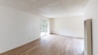 Located at 2461 Warring St in Berkeley, California, this apartment on the second floor presents a thoughtfully designed single-level layout with a clean, neutral aesthetic throughout. The living area is bright and open, featuring smooth wood-style flooring and a textured ceiling. A sliding glass door fills the space with natural light and provides direct access to a private balcony overlooking lush greenery, creating a welcoming indoor-outdoor connection.

The galley-style kitchen is efficiently organized, offering rich wood cabinetry with ample upper and lower storage, granite-look countertops, a stainless steel refrigerator, and a black electric range. The layout maximizes counter space and functionality, making it well-suited for everyday cooking.

The bedroom is a comfortable, well-proportioned space with the same wood-style flooring and a sliding-door closet providing generous storage. An additional carpeted walk-in closet adds further storage flexibility. The bathroom features a clean, all-white tub and shower combination with chrome fixtures.

Throughout the unit, the consistent use of light-toned walls and wood-style flooring creates a cohesive and airy ambiance. This Berkeley apartment combines practical design with comfortable living in a desirable location.
