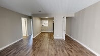 Located at 5350 Arlington Expressway Service Rd in Jacksonville, FL, this single-floor unit offers a well-designed layout with a blend of modern updates and functional living spaces. The open-concept living and dining areas are finished with warm wood-look laminate flooring and neutral gray walls, creating a bright and cohesive atmosphere throughout. The updated kitchen features crisp white shaker-style cabinetry, a white subway tile backsplash, light countertops, a stainless steel sink, and black appliances including a refrigerator, dishwasher, and range. The bedrooms are carpeted for comfort and receive generous natural light through large windows, with one bedroom offering a walk-in closet and access to an en-suite bathroom. Two full bathrooms serve the unit — one featuring a shower/tub combo with white tile surround, and the other showcasing a wide vanity with white cabinetry, stone-look countertops, and a well-lit mirror. The floor plan, visible in the dollhouse view, reflects a practical and spacious layout with clearly defined living, dining, kitchen, and bedroom zones. Clean white trim and consistent neutral tones tie the interior together, offering a move-in ready space suitable for a variety of lifestyles.