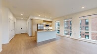 Located in Redmond, WA, this thoughtfully designed residence offers four bedrooms, two bathrooms, and a dedicated laundry room across a single level. The open-concept kitchen and living area serves as the heart of the home, featuring a large central island with a white quartz countertop, warm wood cabinetry, stainless steel appliances, and modern pendant lighting. A bank of floor-to-ceiling windows floods the living area with natural light and provides views of the surrounding community. Light wood-tone flooring runs seamlessly throughout, enhancing the clean, contemporary aesthetic. The spacious primary bedroom includes a generous walk-in closet fitted with wire shelving. Additional bedrooms are well-proportioned, each with large windows that invite natural light and outdoor views of greenery and the neighborhood. The bathrooms are finished with white subway tile surrounds, light wood vanities, quartz countertops, and modern hardware. Recessed lighting and crisp white walls maintain a bright, neutral palette throughout. A dedicated closet and in-unit laundry room add practical convenience. The overall ambiance is modern, airy, and move-in ready, making this Redmond residence a functional and stylish place to call home.