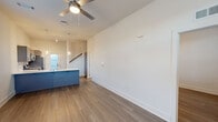 This two-story, 3-bedroom, 2-bathroom home in Huntsville, Alabama offers a thoughtfully designed layout spread across two floors. The main level features an open-concept kitchen and living area with warm wood-look flooring throughout. The kitchen is equipped with stainless steel appliances, gray shaker-style cabinetry, a herringbone tile backsplash, quartz countertops, and a bold blue island with pendant lighting — combining style and functionality. The living area is bright and airy, with a ceiling fan and large windows that invite natural light. A front-facing door provides convenient outdoor access directly from the main living space. Upstairs, the generously sized primary bedroom includes a ceiling fan, natural light from windows, and access to a well-appointed en-suite bathroom featuring a dual-sink vanity with gray cabinetry, quartz countertops, and a walk-in shower. Three spacious closets with wire shelving offer ample storage throughout the home. A dedicated laundry room with washer and dryer hookups, wire shelving, and a natural light window adds everyday convenience. The clean, neutral palette and modern finishes create a cohesive, move-in ready atmosphere throughout the entire home.
