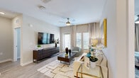 Located at 16520 Windsor Cay Blvd in Clermont, FL, this single-story 2-bedroom, 2-bathroom home offers a well-appointed open-concept layout with modern finishes throughout. Light wood-tone flooring flows seamlessly across the main living areas, complemented by neutral tones that create a bright, welcoming ambiance.

The kitchen is a standout feature, boasting white shaker cabinetry, stainless steel appliances, a tile backsplash, and a large center island with pendant lighting and bar seating — perfect for casual dining or entertaining. It opens directly into the spacious living room, which is filled with natural light from large windows and a glass door, and is equipped with a ceiling fan.

The primary bedroom offers a comfortable retreat with generous proportions, multiple windows, a ceiling fan, and access to a well-sized walk-in closet with wire shelving. The en-suite primary bathroom features a dual-sink vanity with white cabinetry, a frameless glass walk-in shower with tile surround, and wood-look flooring. The second bedroom is equally inviting, with natural light and its own closet. A dedicated utility room, hallway, and additional bathroom round out the floor plan. Both closets feature practical wire shelving systems for organized storage.