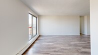Located at 45 Barlake Avenue in Hamilton, Ontario, this single-floor, 2-bedroom, 1-bathroom unit offers a well-organized layout connecting a living room, kitchen, two bedrooms, bathroom, and hallway. The living room is one of the most prominent spaces, featuring grey laminate flooring, a textured ceiling, and large sliding glass doors opening to a balcony with open city views. An additional window further enhances natural light throughout the area. The kitchen is accessible directly from the living space and is finished with light tile flooring, dark cabinetry, and a granite-style countertop offering generous prep space. Both bedrooms are finished with light grey laminate flooring, crisp white walls, and full-width sliding closets providing ample storage. The primary bedroom includes a large window framing outdoor views, while the second bedroom is similarly bright. The bathroom features a soaker tub and shower combination surrounded by clean white subway tiles, accented by a decorative mosaic tile border and polished chrome fixtures, contributing to a fresh, functional aesthetic throughout the unit.