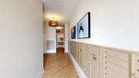 Located at 1020 Port Royal Trail in Myrtle Beach, SC, this single-floor amenity suite offers a thoughtfully designed collection of resident-focused spaces. The welcoming hallway features warm wood-look flooring, stylish gold pendant lighting, and a full wall of individual mailboxes, accented by coastal-themed artwork that reflects the surrounding South Carolina environment. A dedicated Amazon Hub parcel locker station provides a secure and convenient package retrieval solution.

The two office spaces are bright and functional, each benefiting from natural light through slatted window blinds. One features a round conference table with modern seating, built-in shelving, and a gold pendant fixture, making it well-suited for meetings or private work sessions.

A spacious bike room stands out with its polished concrete floors, bold horizontal accent stripe along the walls, and modern linear lighting overhead. The room accommodates multiple bicycles on floor and wall-mounted racks, with natural light filtering in through large windows.

A dedicated pet grooming room rounds out the suite's offerings, featuring striking black-and-white hexagonal tile flooring, a stainless steel grooming table, a mounted pet dryer, and ample natural light — a practical and stylish space for residents and their pets.